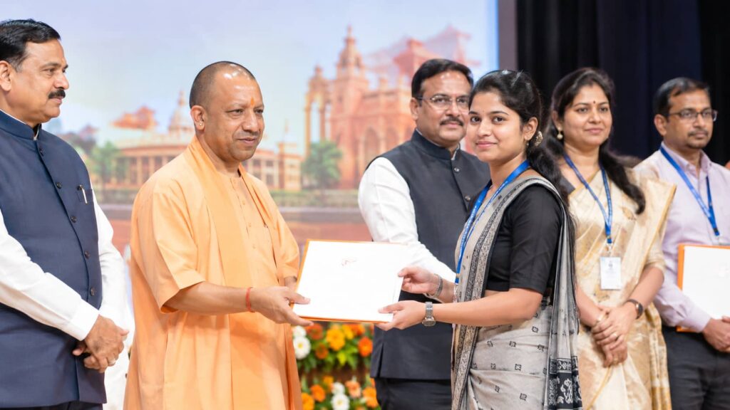 Yogi Adityanath handing appointment letter to selected teacher in UP Teacher Appointment 2026